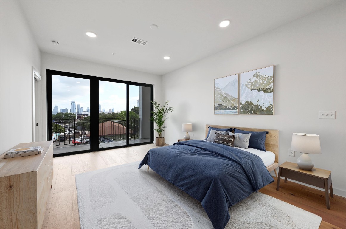 2209 South 1st Street, Unit 209 Austin, TX 78704 - Photo 2 of 33 a spacious bedroom with a large bed and a large window