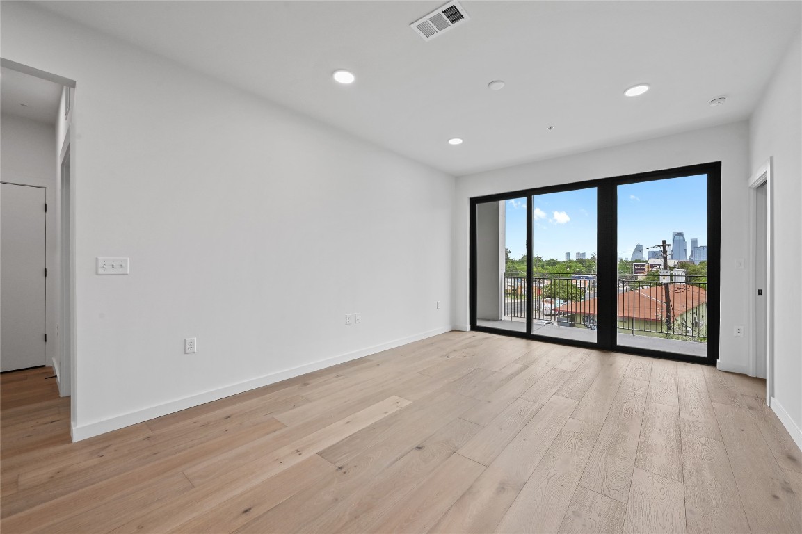 2209 South 1st Street, Unit 209 Austin, TX 78704 - Photo 4 of 33 wooden floor in an empty room with a window