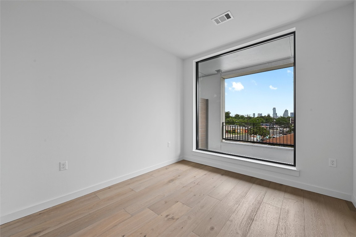 2209 South 1st Street, Unit 209 Austin, TX 78704 - Photo 6 of 33 a view of a room with wooden floor and window