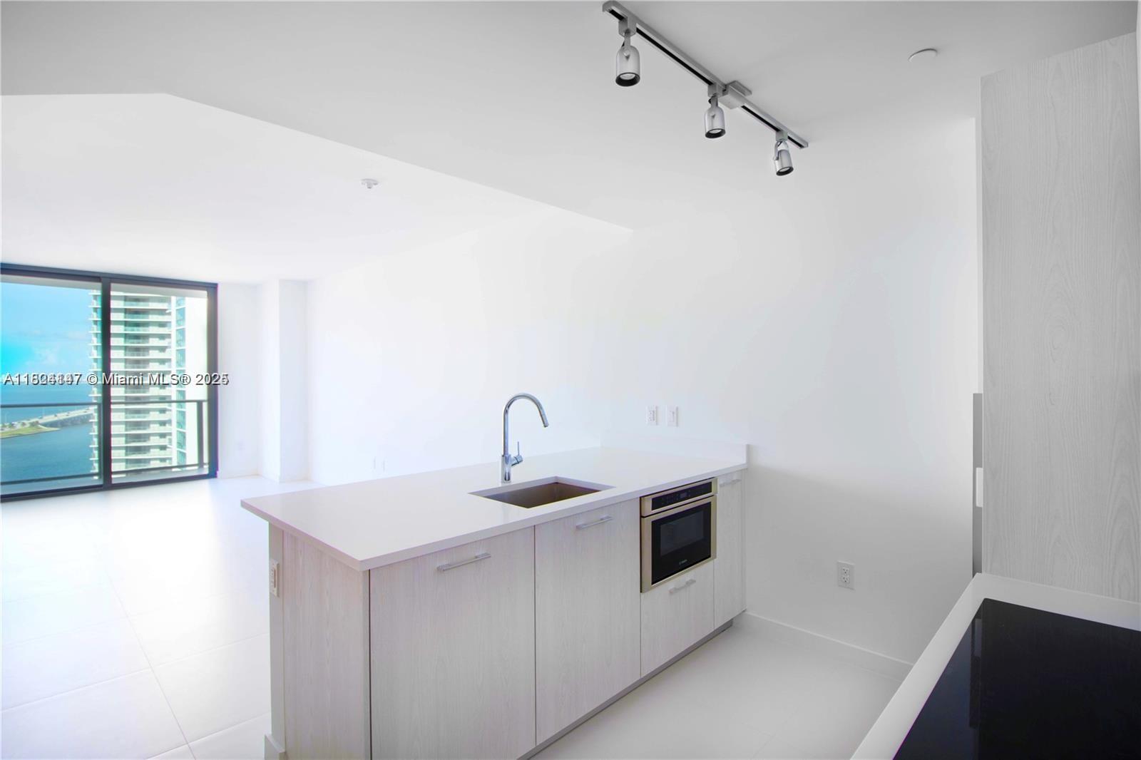 a kitchen with a sink and cabinets