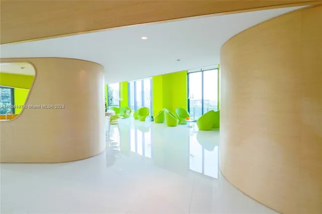 a room with pool table and windows