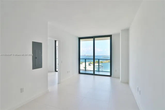 an empty room with windows and closet