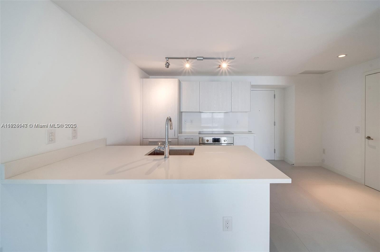 501 Northeast 31st Street, Unit 2005 Miami, FL 33137 - Photo 4 of 30 a view of a kitchen with a sink and chandelier