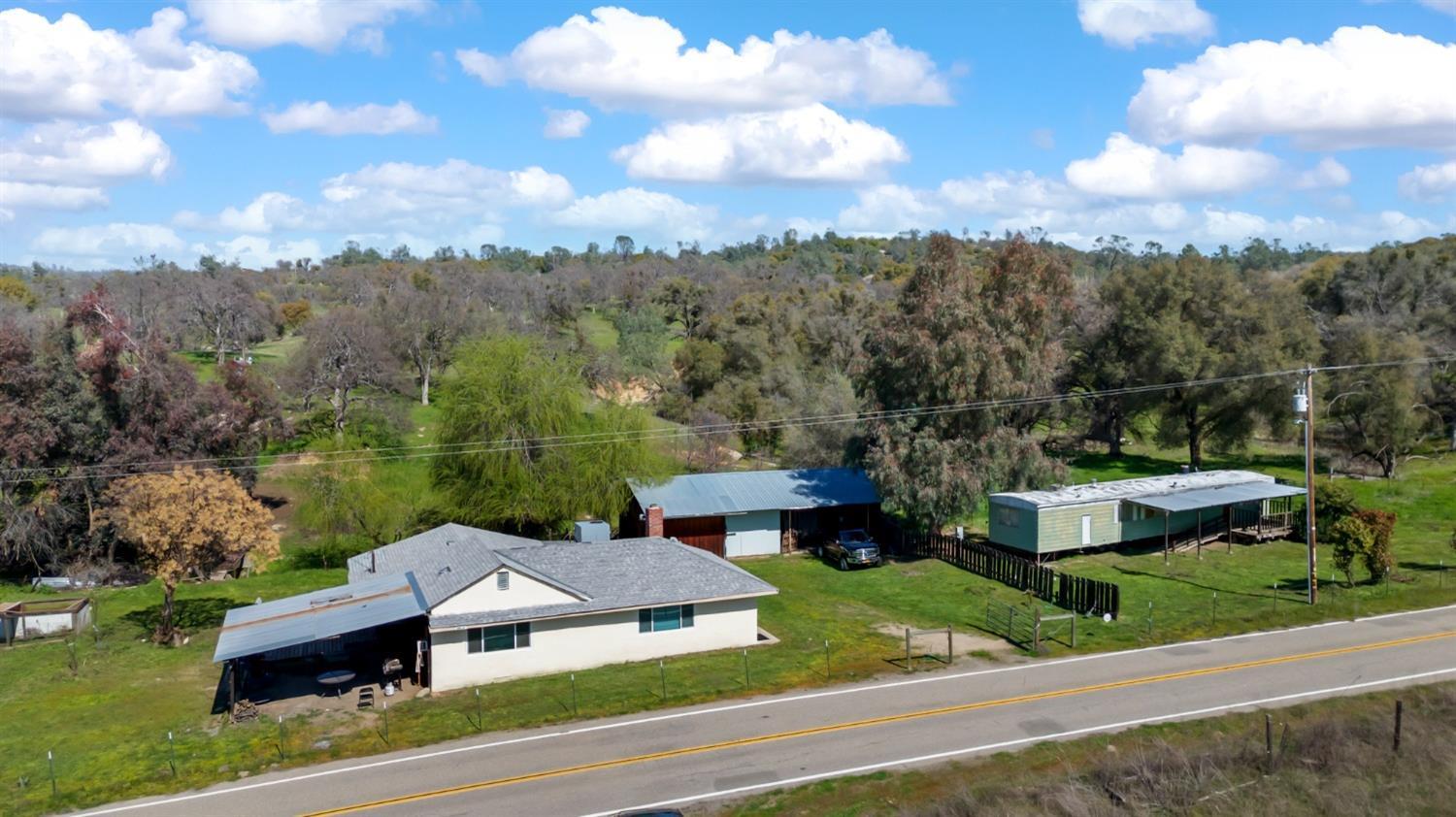 a view of houses with yard and mountain view in back