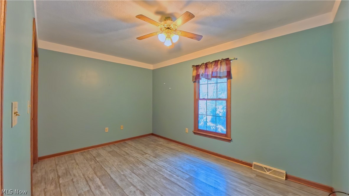 48276 Dyke Road Negley, OH 44441 - Photo 16 of 30 Empty room featuring light wood finished floors and a ceiling fan
