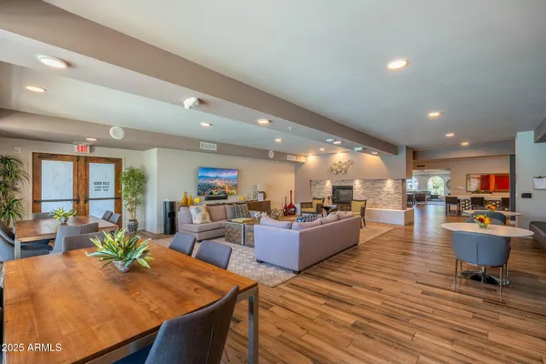 a living room with furniture and a wooden floor