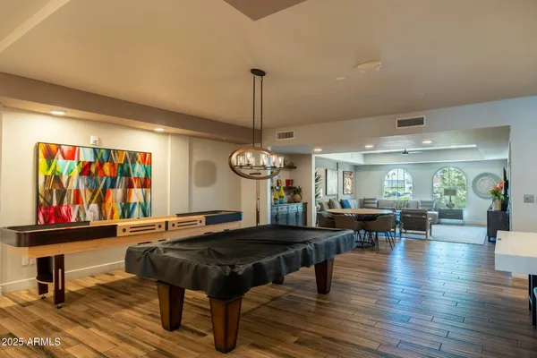 a living room with furniture a window and wooden floor
