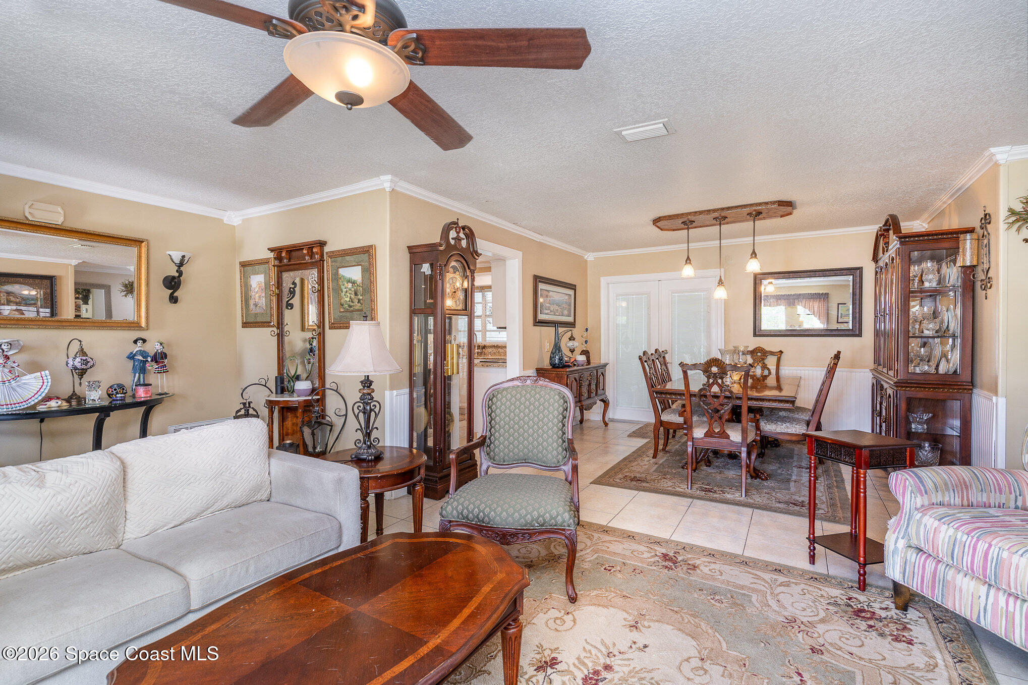 a living room with furniture kitchen view and a large window