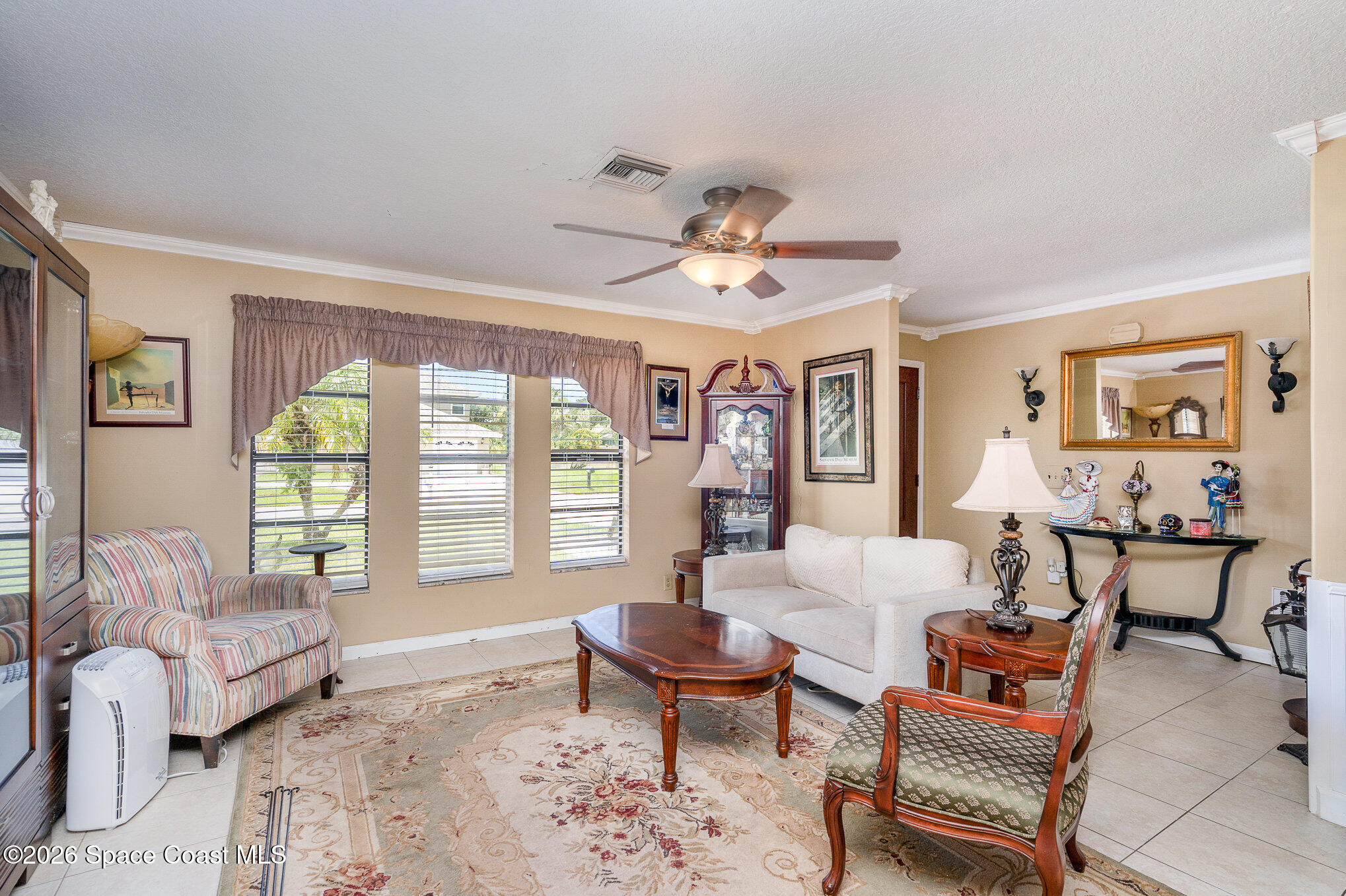 1069 Fairlawn Drive Rockledge, FL 32955 - Photo 11 of 30 a living room with furniture and a large window