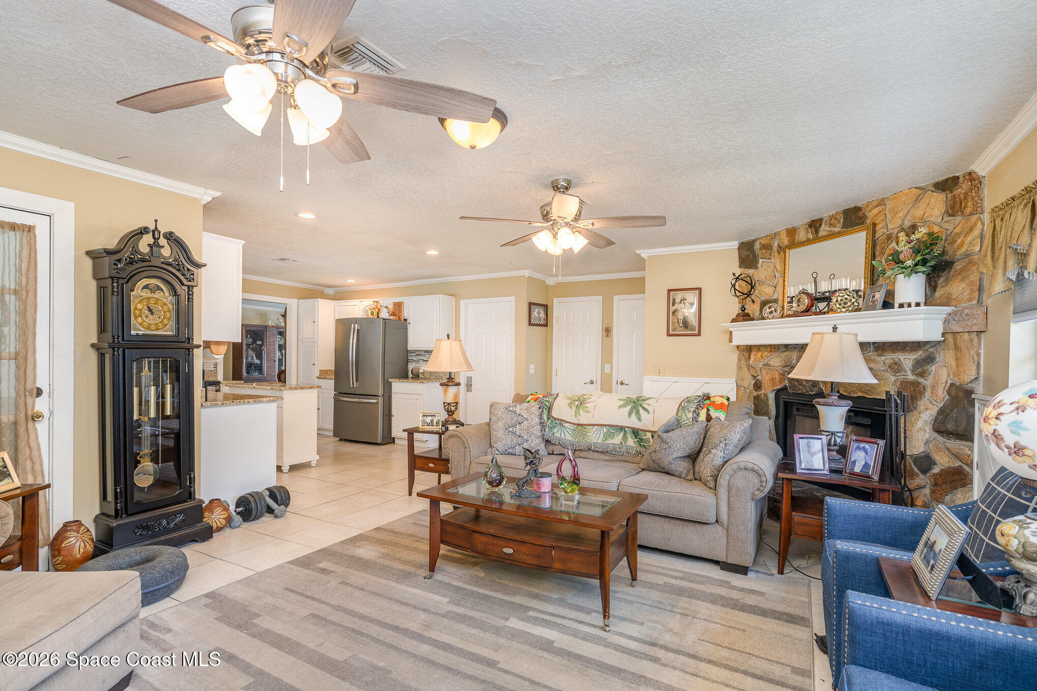 1069 Fairlawn Drive Rockledge, FL 32955 - Photo 13 of 30 a living room with fireplace furniture and a chandelier