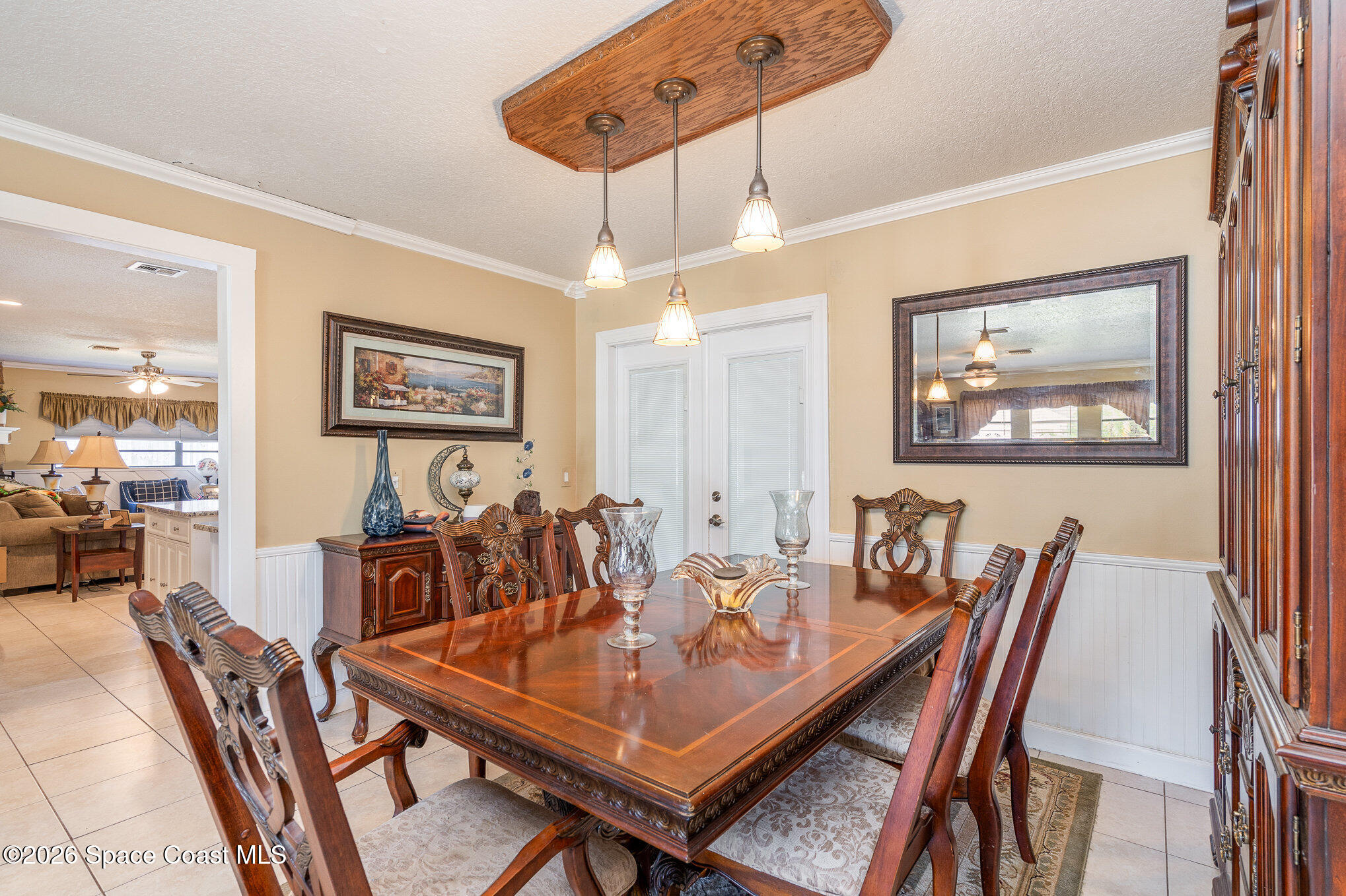 1069 Fairlawn Drive Rockledge, FL 32955 - Photo 18 of 30 a view of a dining room and livingroom with furniture wooden floor a rug a painting and a chandelier