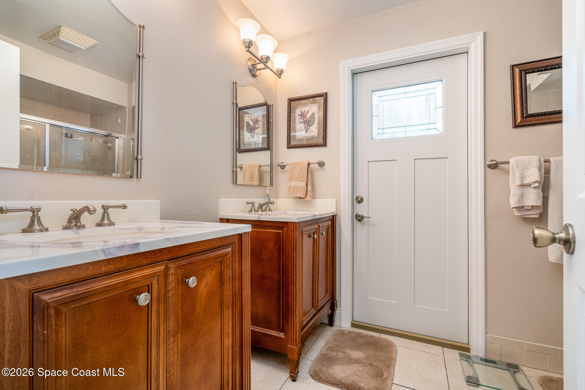 1069 Fairlawn Drive Rockledge, FL 32955 - Photo 26 of 30 a bathroom with a granite countertop sink a mirror a vanity and shower