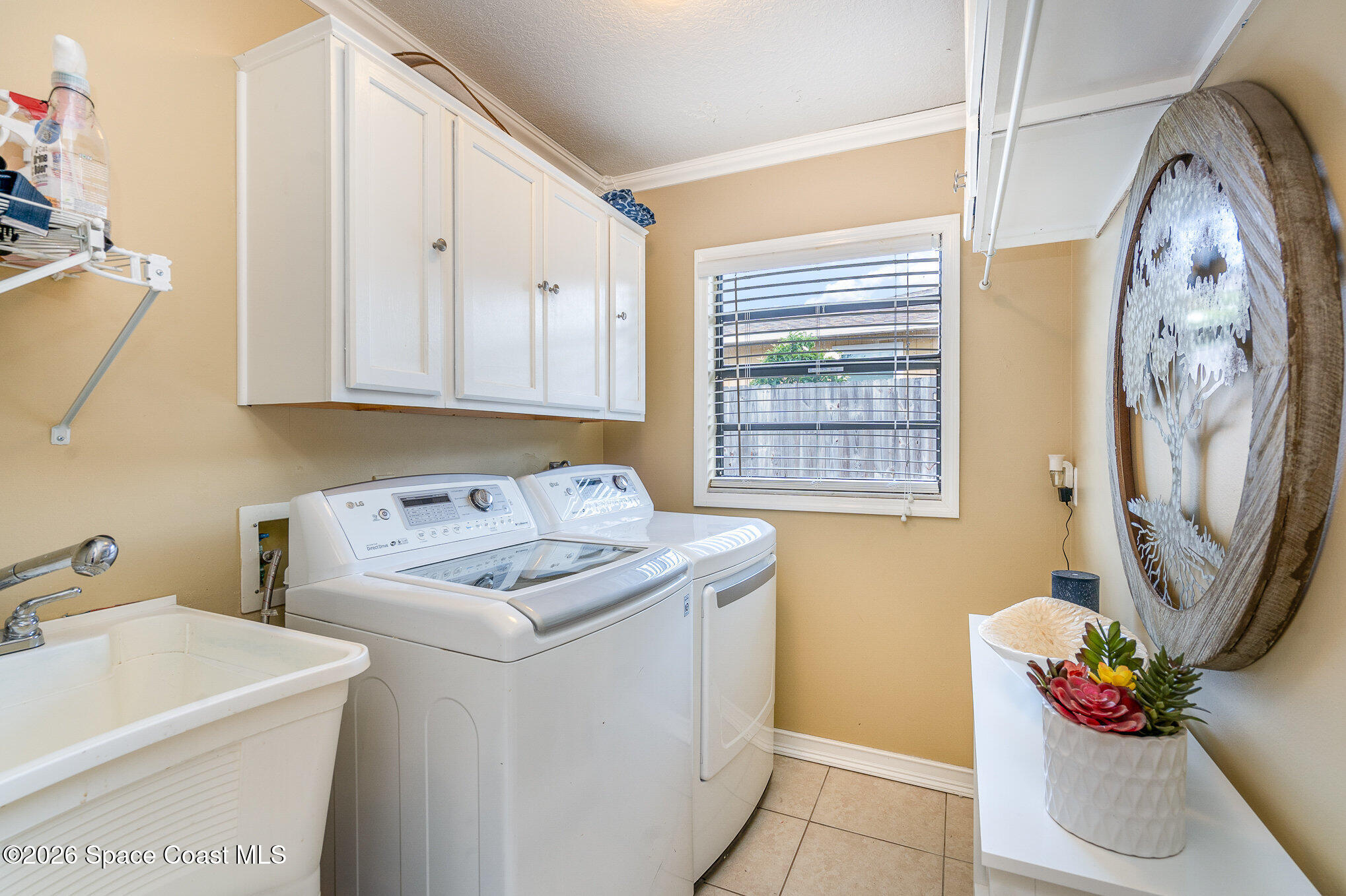 1069 Fairlawn Drive Rockledge, FL 32955 - Photo 27 of 30 a utility room with a sink a washer and dryer