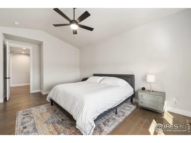 a bedroom with a bed and a ceiling fan
