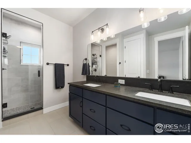 a bathroom with double sink and a mirror