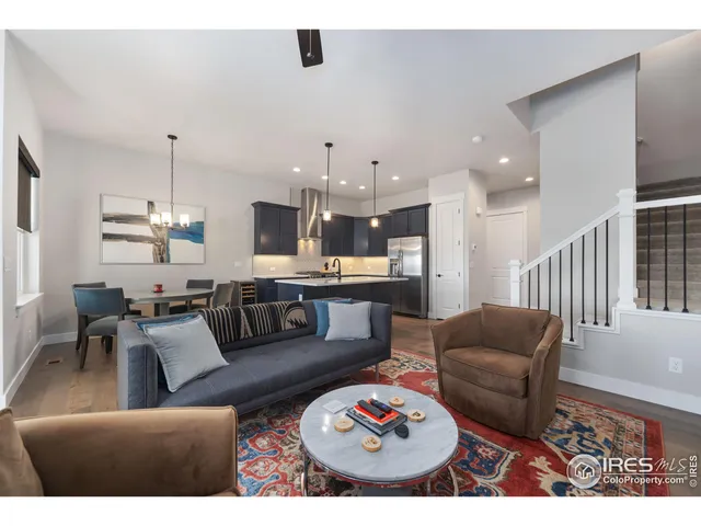 a living room with furniture and kitchen view