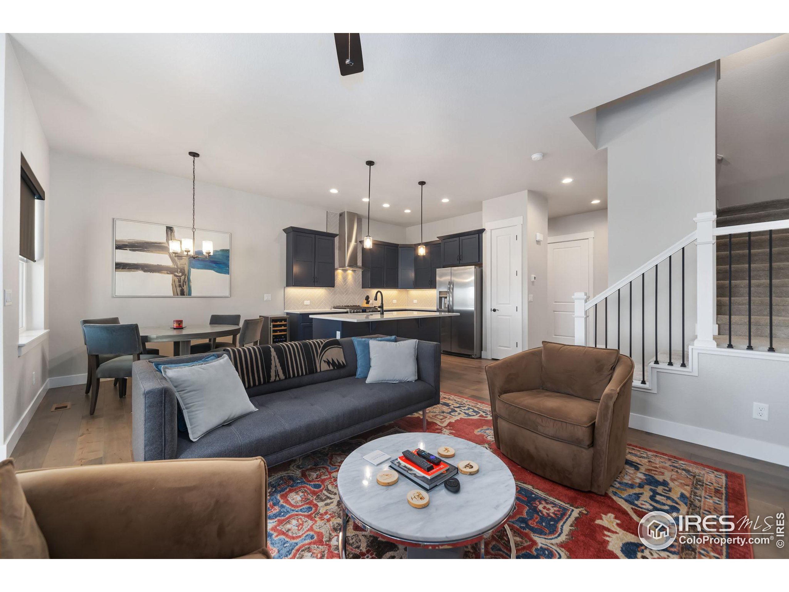 2748 Prairie Flax Street Berthoud, CO 80513 - Photo 6 of 40 a living room with furniture and kitchen view