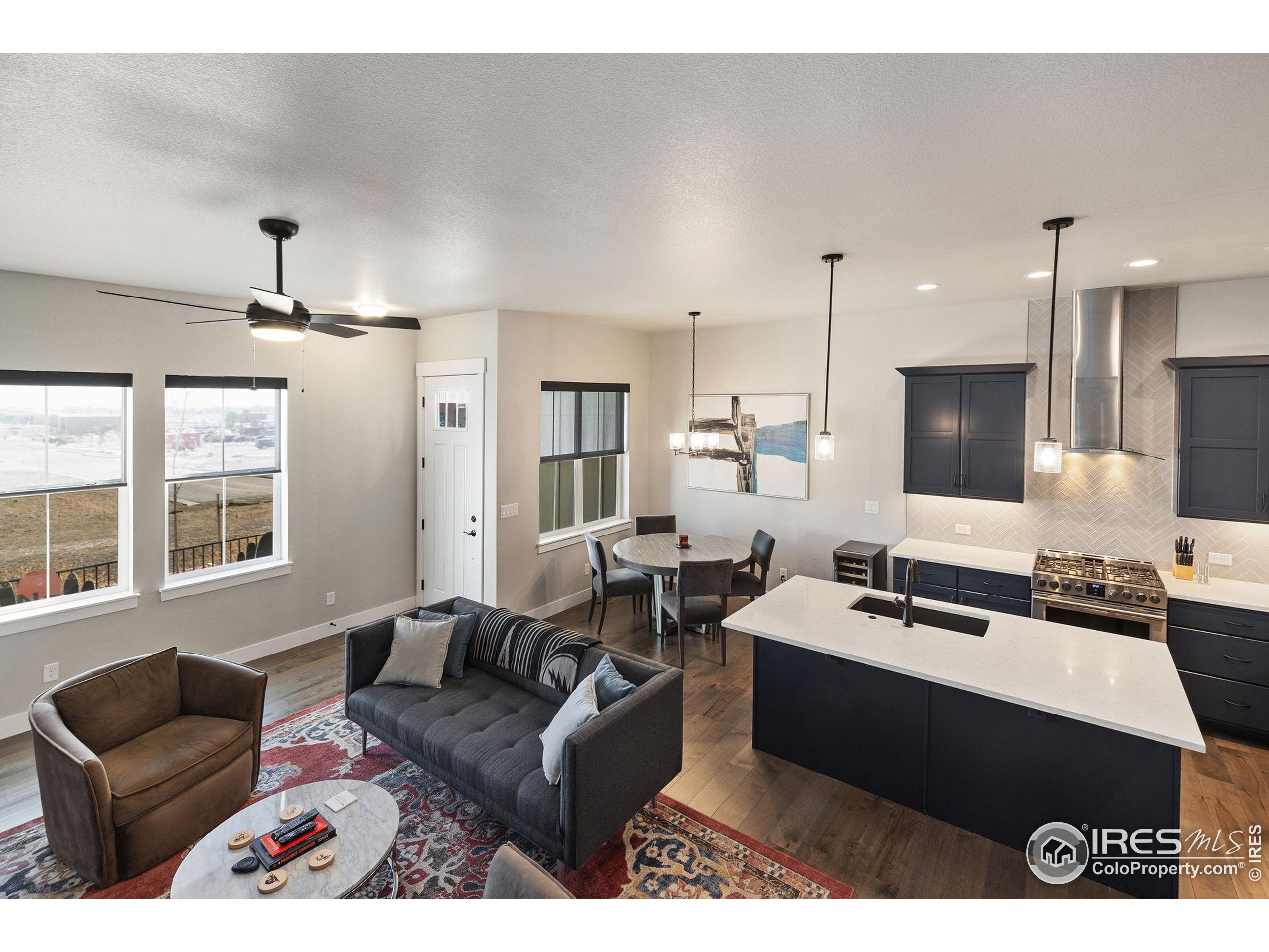 2748 Prairie Flax Street Berthoud, CO 80513 - Photo 7 of 40 a living room with furniture kitchen view and a large window