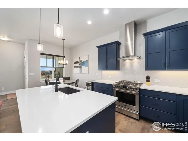 a kitchen with stainless steel appliances a sink stove and refrigerator