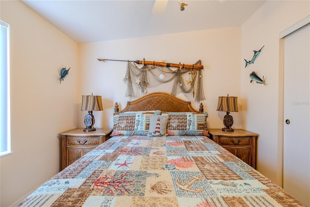 126 Charles Street Edgewater, FL 32141 - Photo 33 of 40 a bedroom with a bed and a lamp