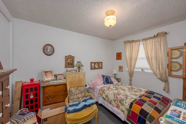 a bedroom with bed and a bookshelf