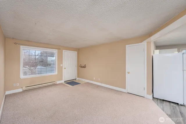 an empty room with a empty space and windows