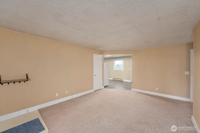 an empty room with a empty space and a window