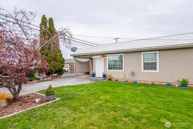 a view of a house with a yard and sitting area