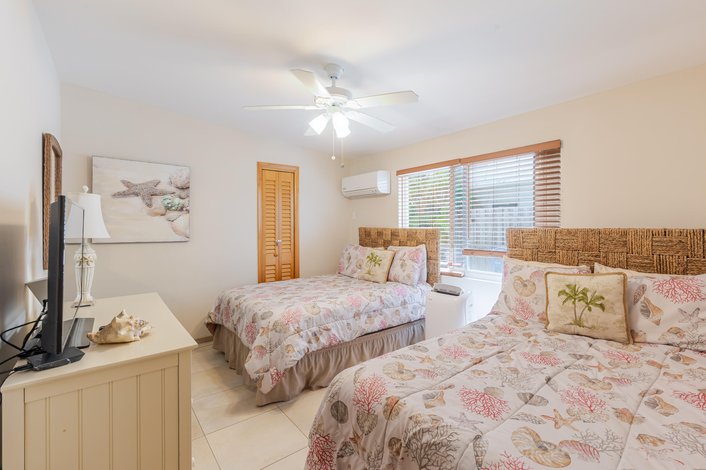 341 3rd Street Key Colony Beach, FL 33051 - Photo 19 of 42 a bedroom with two beds and a chandelier