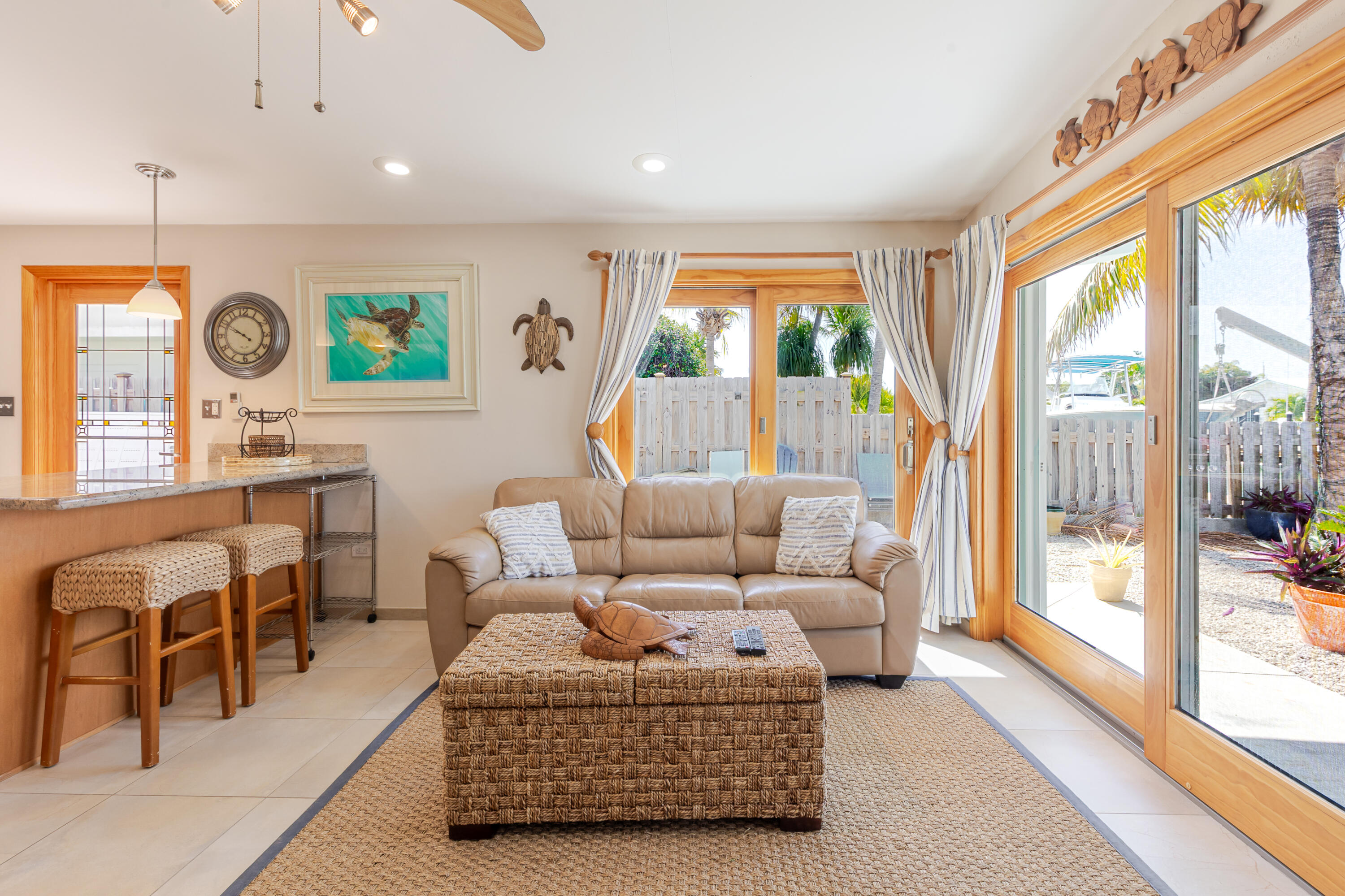 341 3rd Street Key Colony Beach, FL 33051 - Photo 23 of 42 a living room with furniture a large window and a clock