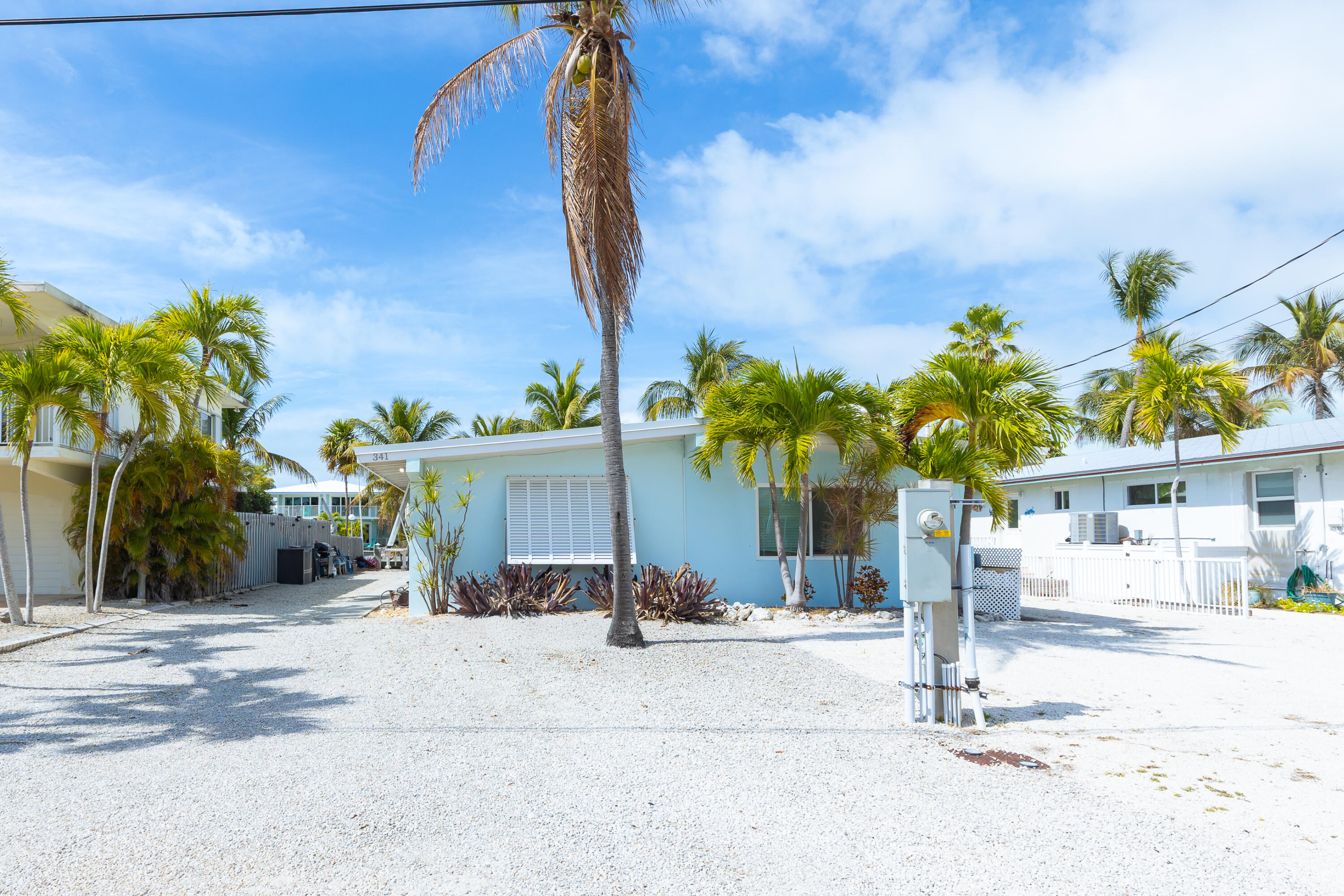 341 3rd Street Key Colony Beach, FL 33051 - Photo 29 of 42 a front view of a house with a yard and a garage