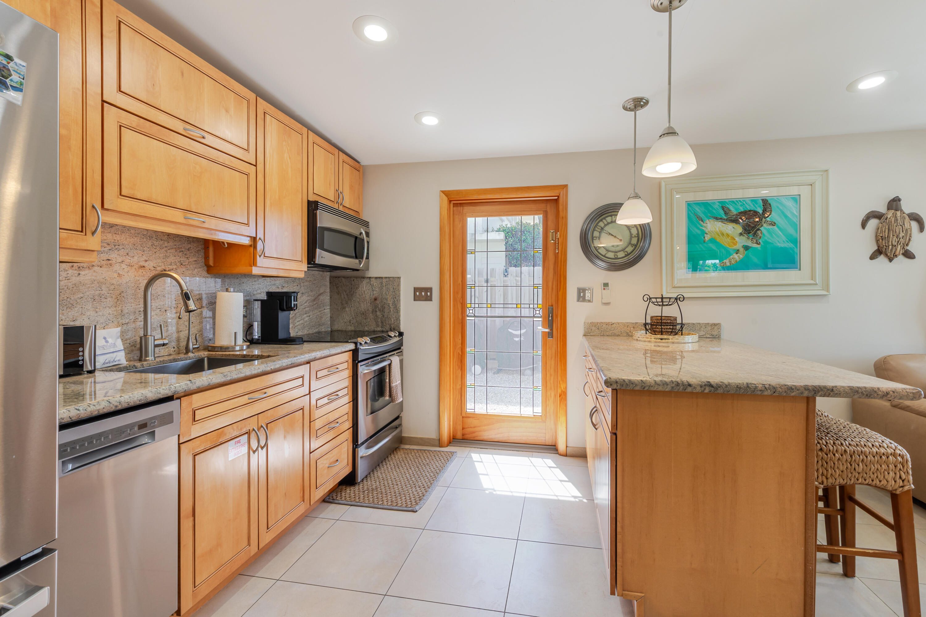 341 3rd Street Key Colony Beach, FL 33051 - Photo 31 of 42 a kitchen with stainless steel appliances granite countertop a sink and a refrigerator