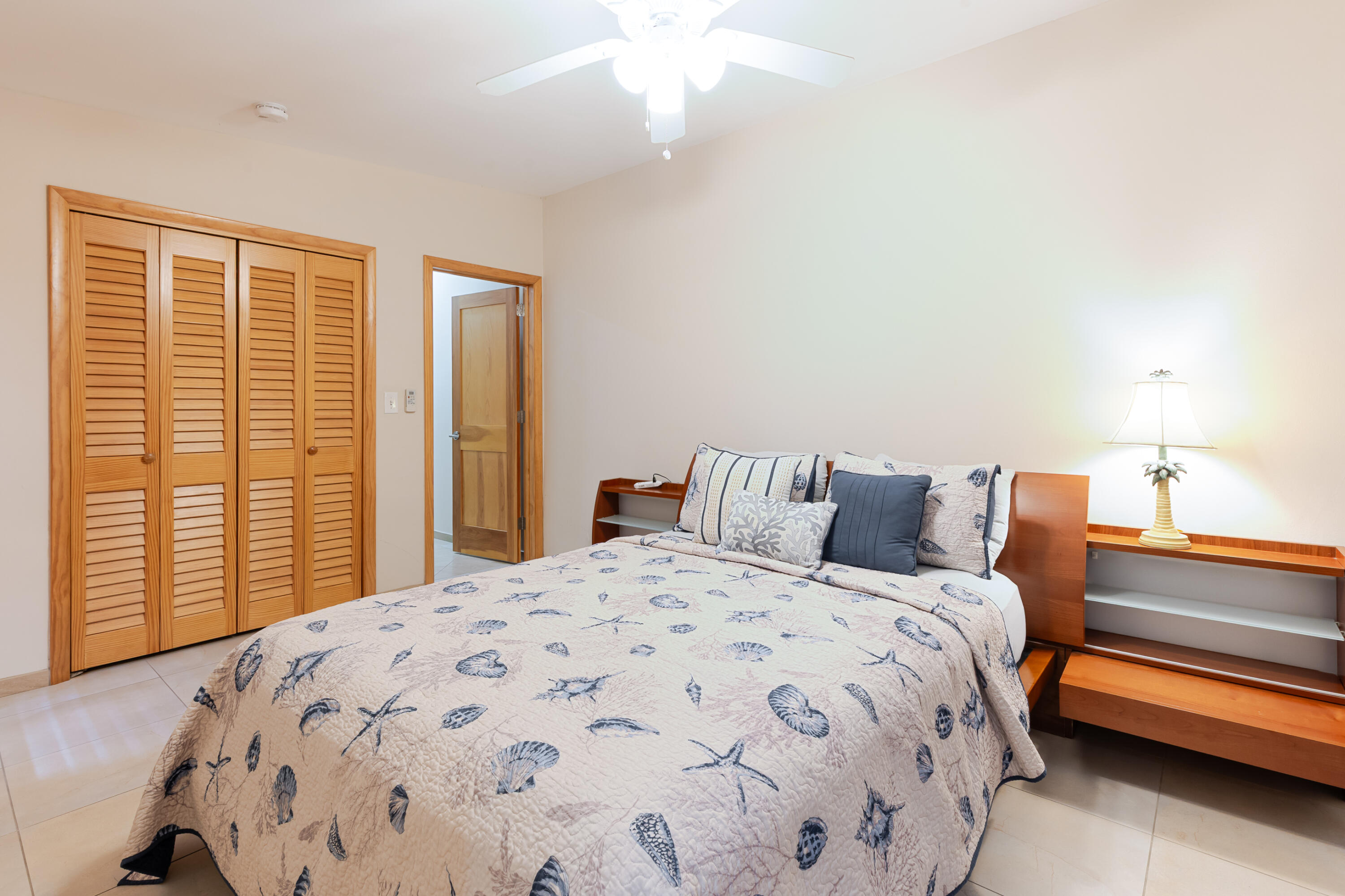 341 3rd Street Key Colony Beach, FL 33051 - Photo 37 of 42 a bedroom with a large bed and a chandelier