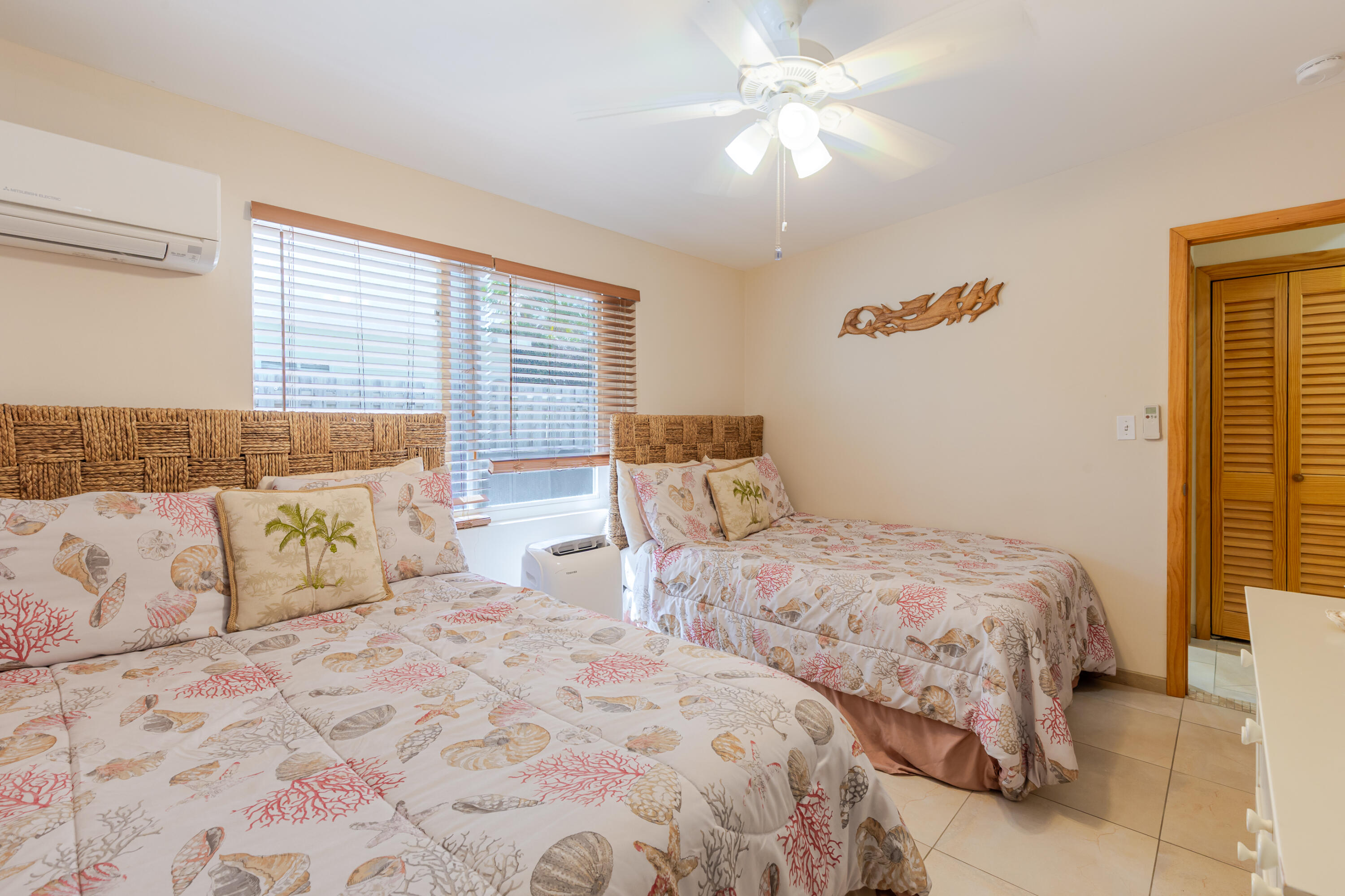 341 3rd Street Key Colony Beach, FL 33051 - Photo 38 of 42 a bedroom with two large bed and a chandelier