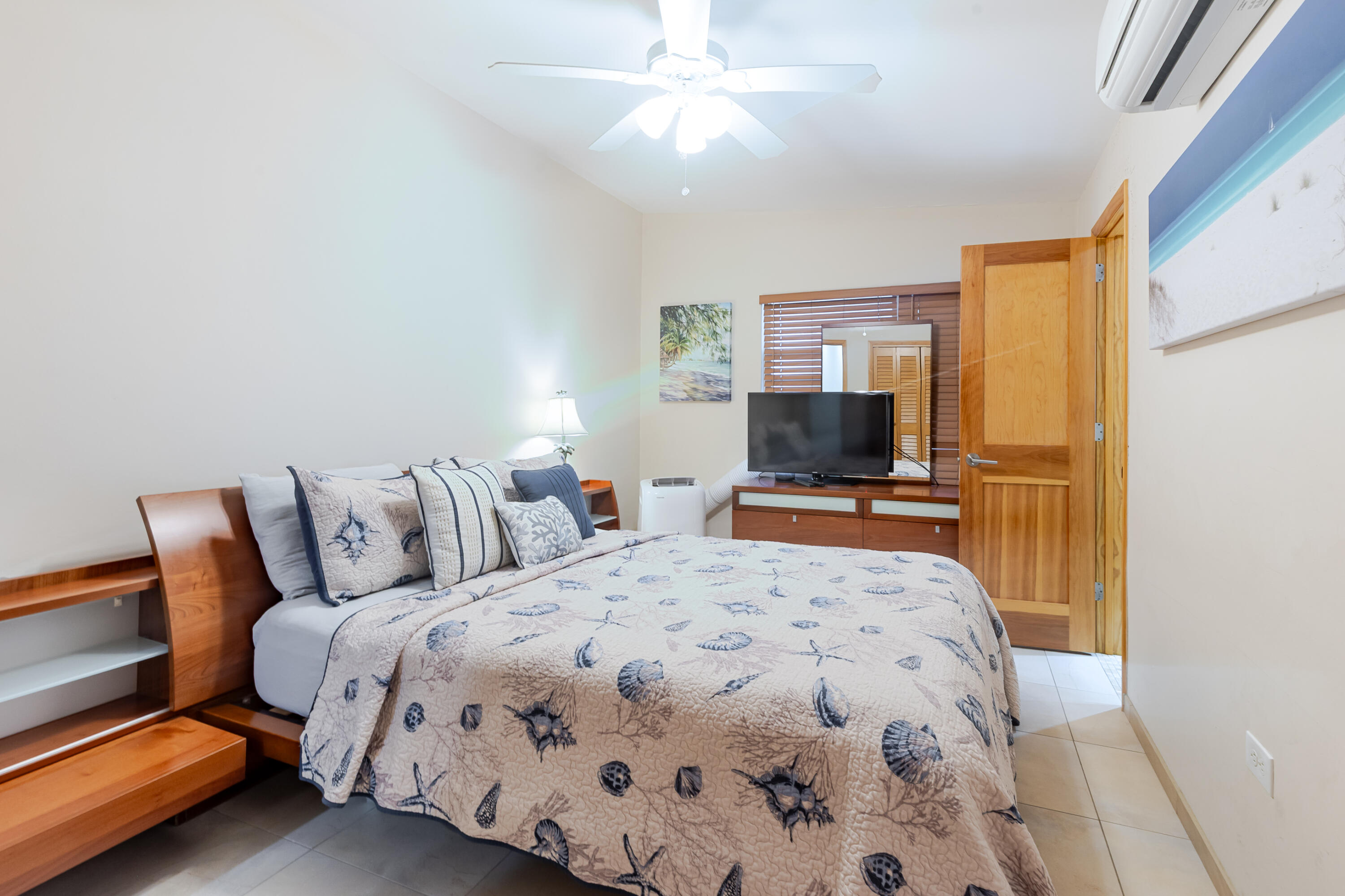 341 3rd Street Key Colony Beach, FL 33051 - Photo 39 of 42 a bedroom with a bed and a flat screen tv