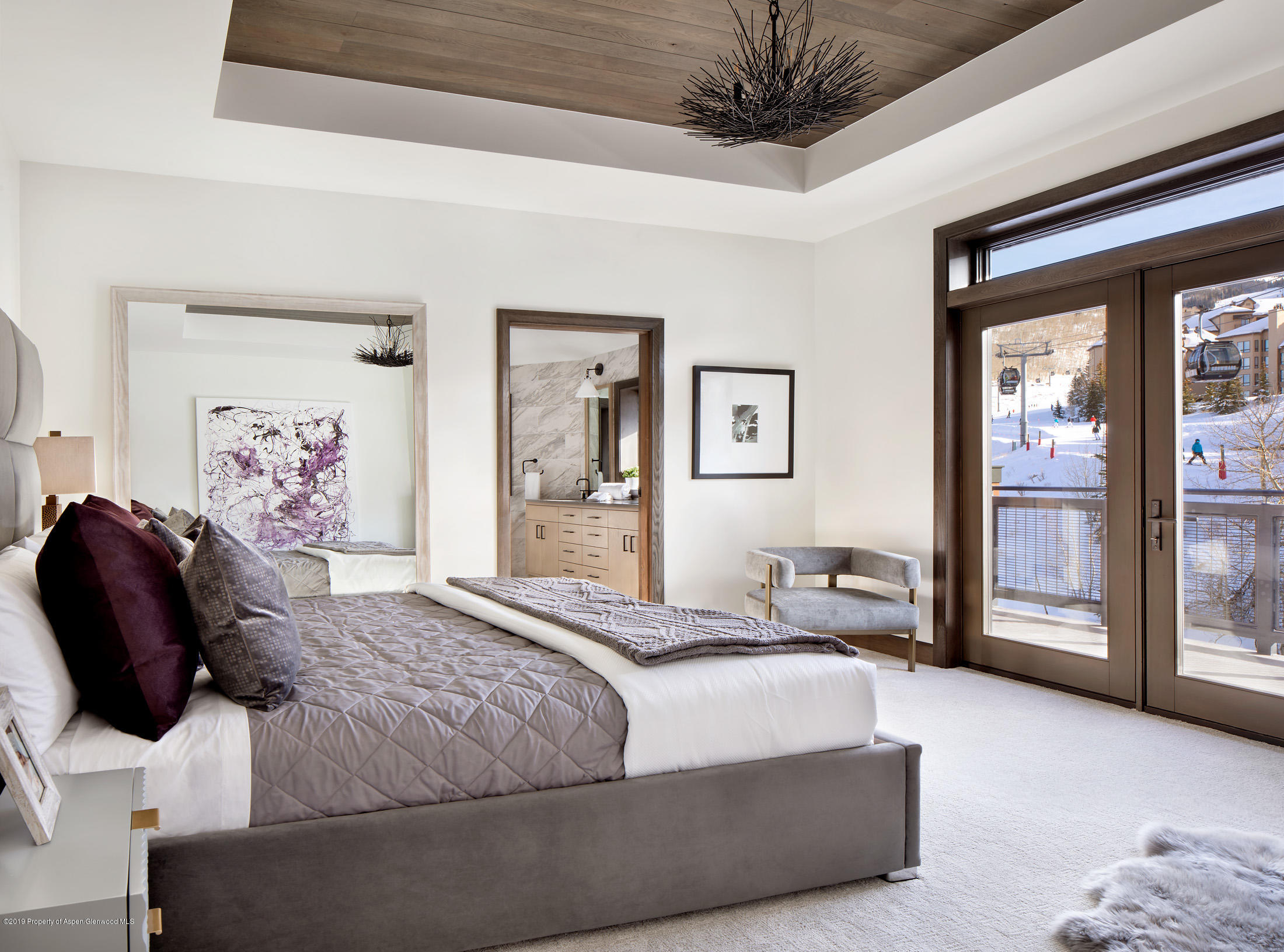 65 Wood Road, Unit 517 Snowmass Village, CO 81615 - Photo 5 of 7 a bedroom with a large bed couch and a window