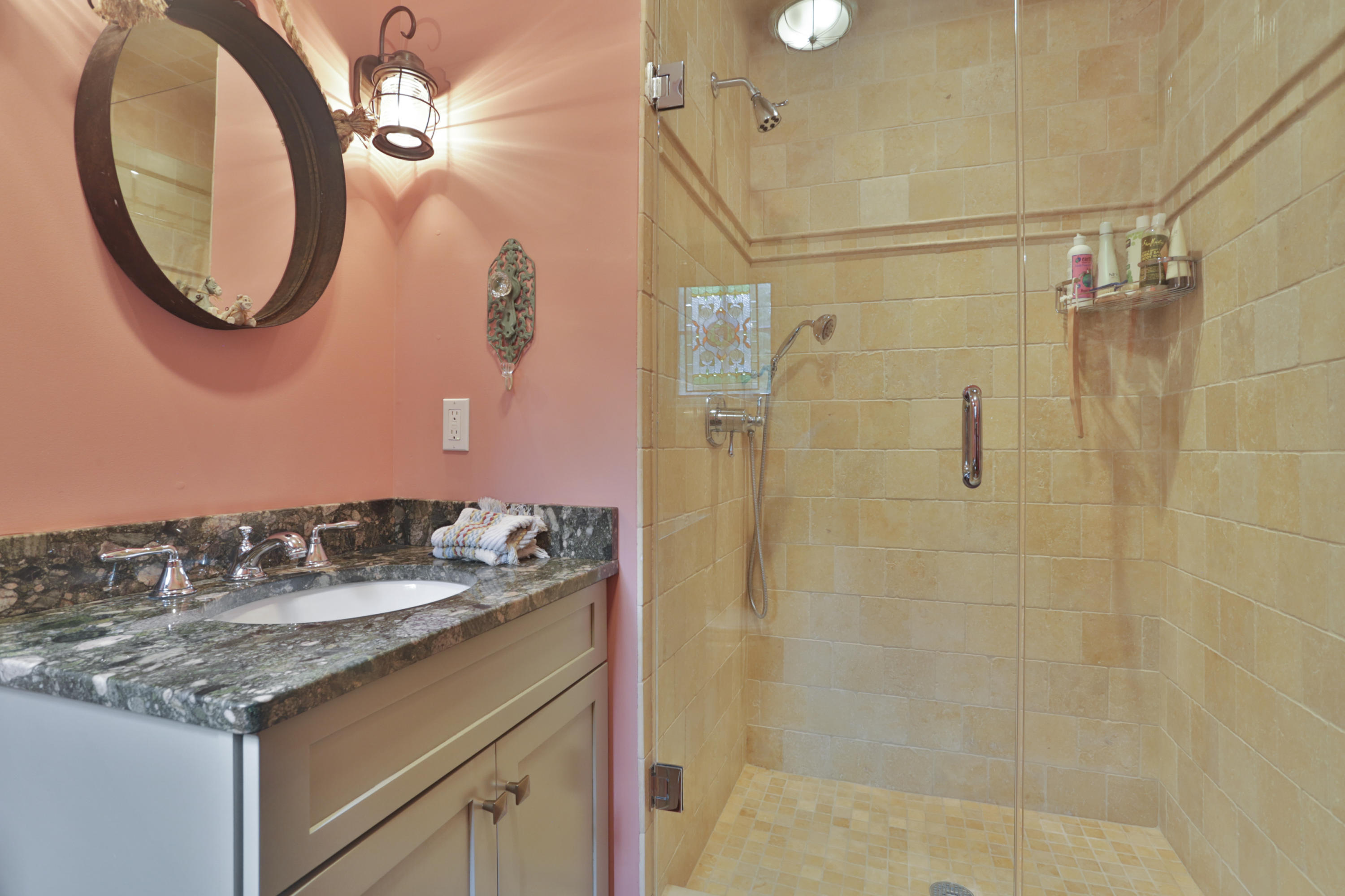 494 June Road Stamford, CT 06831 - Photo 33 of 47 a bathroom with a granite countertop sink a mirror and shower