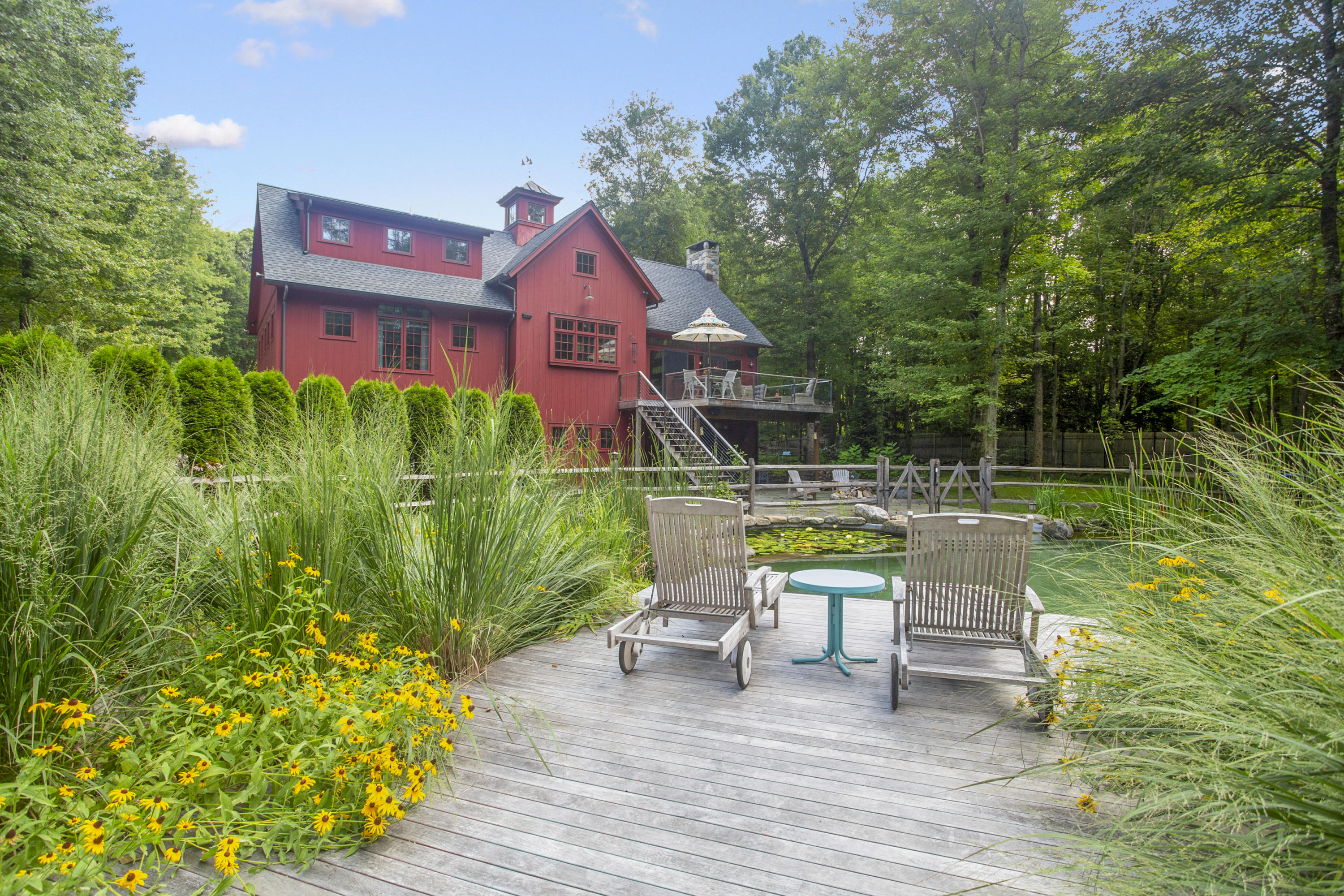 494 June Road Stamford, CT 06831 - Photo 40 of 47 a view of house with a swimming pool and outdoor seating
