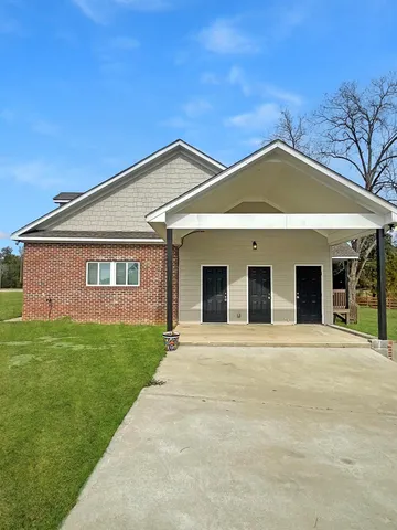 a front view of a house with garden