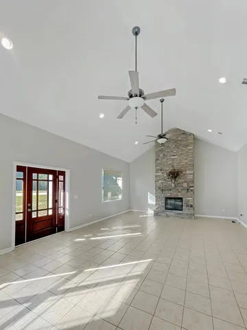 a large white kitchen with cabinets