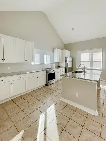 a view of an empty room with a fireplace and a window