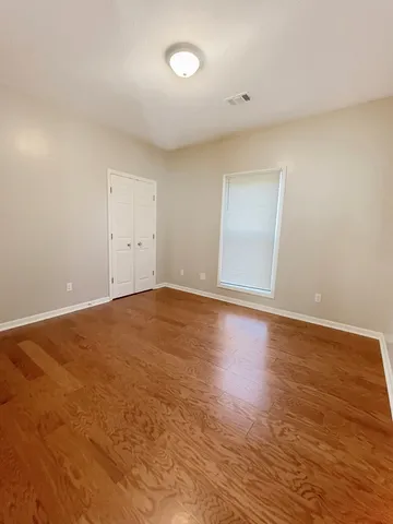 a view of an empty room and wooden floor