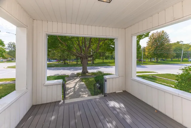 a view of a two room with wooden floor and outdoor space