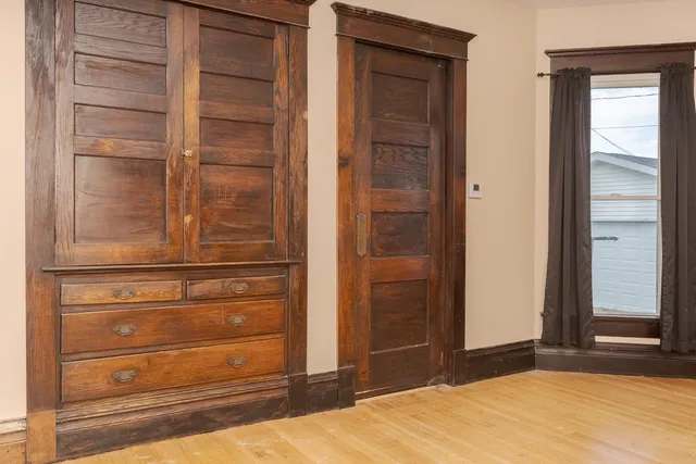 a view of hallway with wooden floor