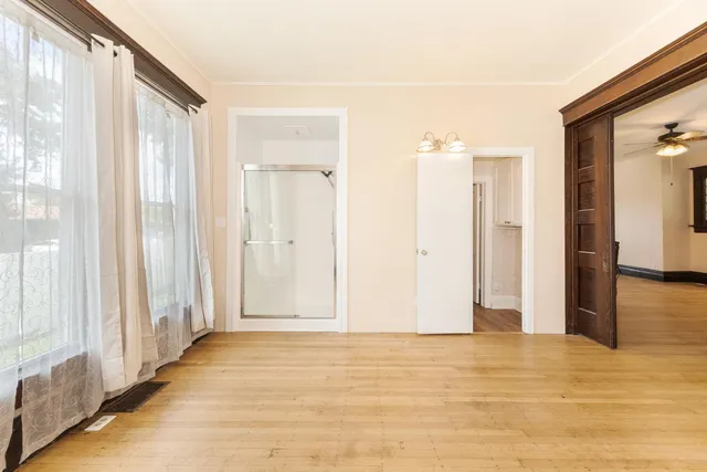 a view of empty room with wooden floor and cabinet