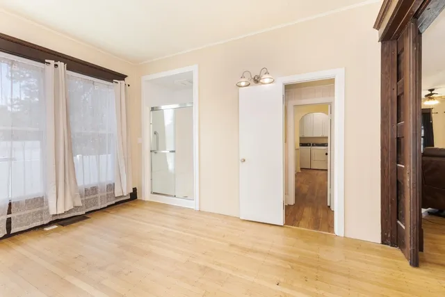 a bathroom with a sink toilet vanity and shower