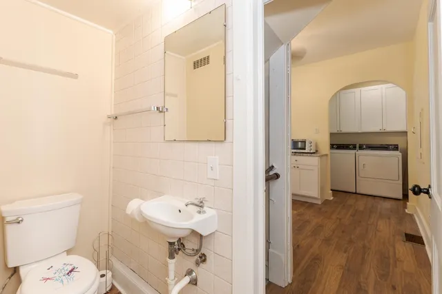 a kitchen with a refrigerator wooden floor and a sink