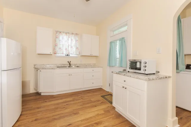 a view of washer and dryer with kitchen view