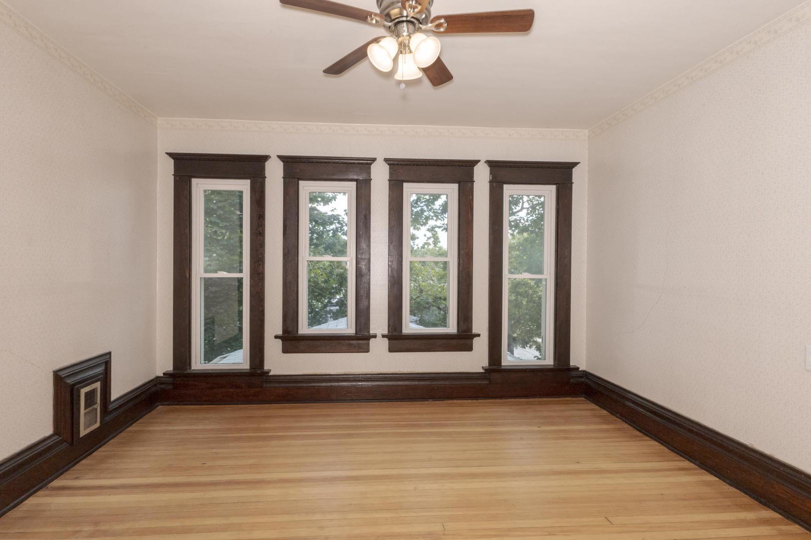 409 West Water Street Pontiac, IL 61764 - Photo 33 of 55 a view of a livingroom with wooden floor and a ceiling fan