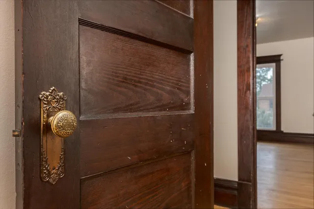 a view of a room with wooden floor